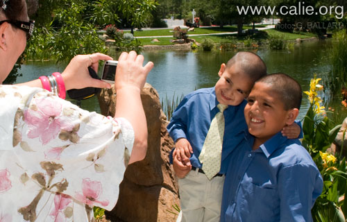 Ernie Salgado is pictured in the background wearing hat and sun glasses