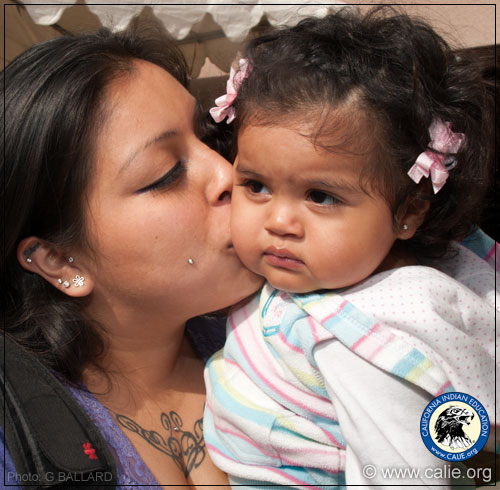 MOTHER KISSING BABY DAUGHTER